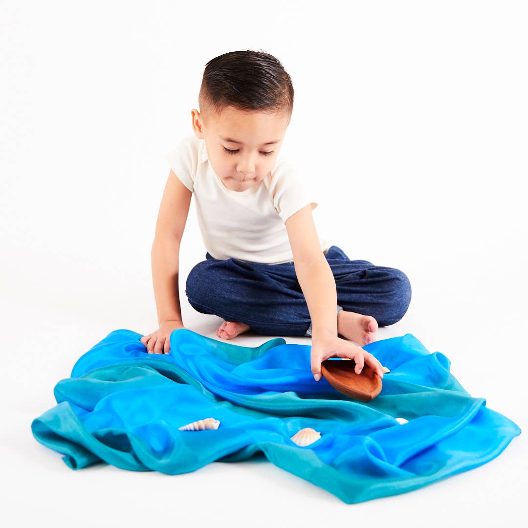 Bright and soft, the Sarah’s Silks Earth Playsilk in Stone encourages pretend play and learning.