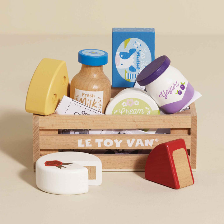 Little shoppers will love the Le Toy Van Cheese & Dairy Wooden Market Crate, a wooden toy for creative play.