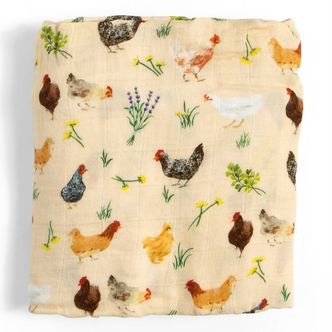 Chicken Meadows muslin swaddle blanket by 1canoe2 folded flat, showing chicken and rooster print for newborns