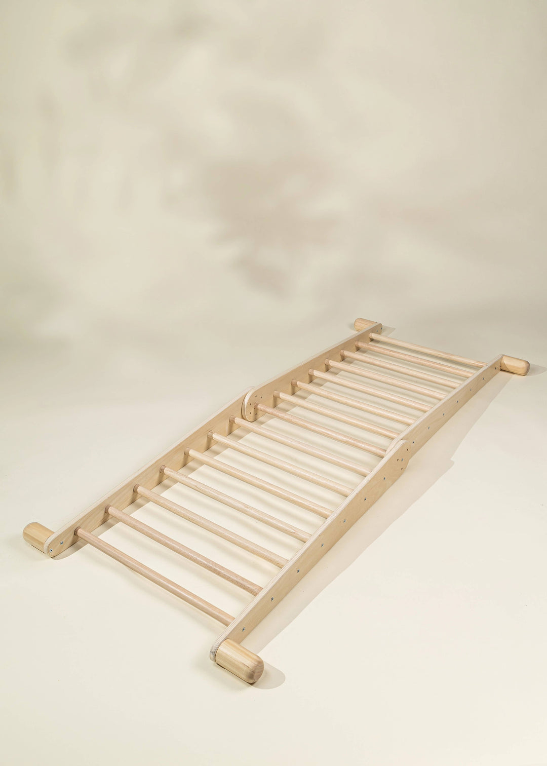 Set the stage for movement with the Coco Village Montessori 2-in-1 Triangle & Wall Climber in Natural, a safe wooden toy for gross motor skills.