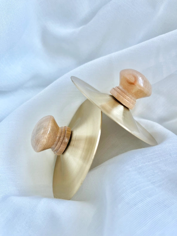 Set atop a neutral background, the All Wooden Elements Pair of 2 Petit Cymbals offers handcrafted charm for those seeking musical toys.