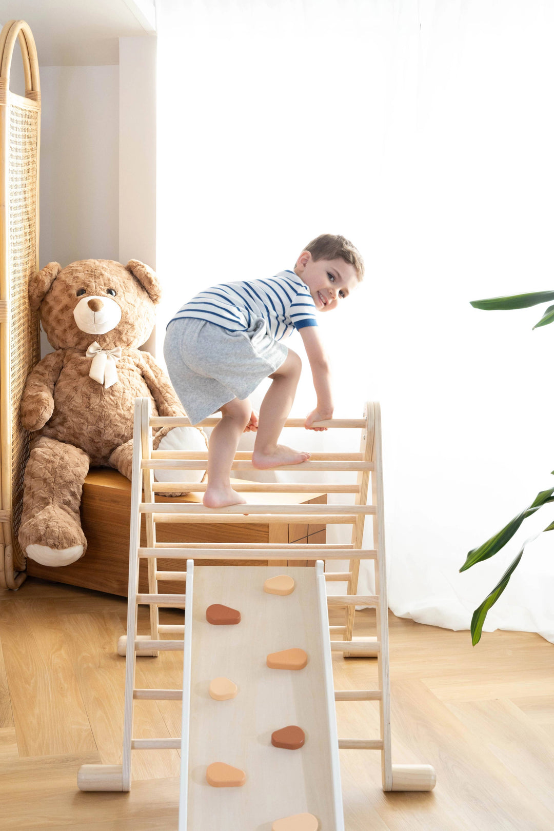 Add purposeful play to your space with the Coco Village Montessori 2-in-1 Grip Climber Board & Slide in Natural wood tones, great for pretend play setups.