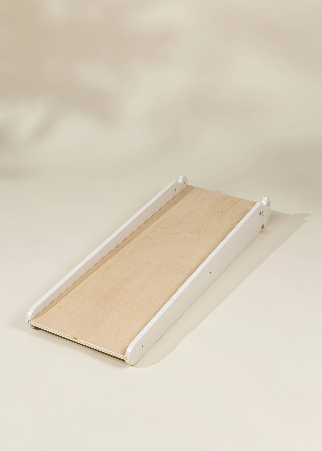 Perfectly designed for indoor fun, the Coco Village Montessori 2-in-1 Grip Climber Board & Slide in Natural is a timeless wooden toy.