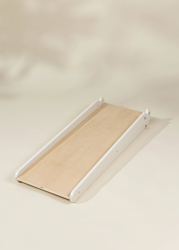 Perfectly designed for indoor fun, the Coco Village Montessori 2-in-1 Grip Climber Board & Slide in Natural is a timeless wooden toy.