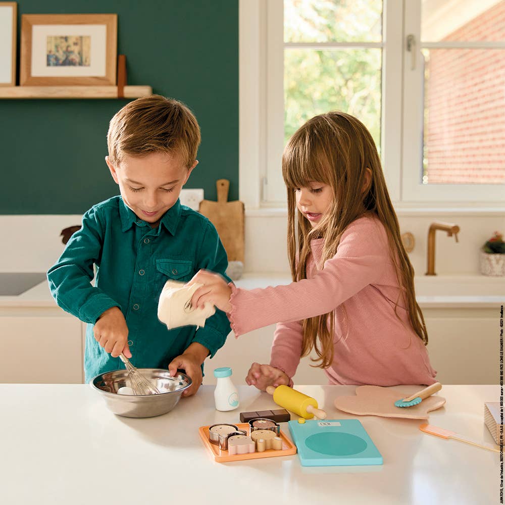 Toddler using Janod My Pastry Workshop for imaginative baking play