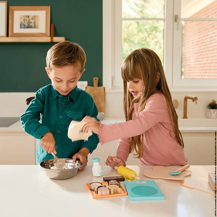 Toddler using Janod My Pastry Workshop for imaginative baking play