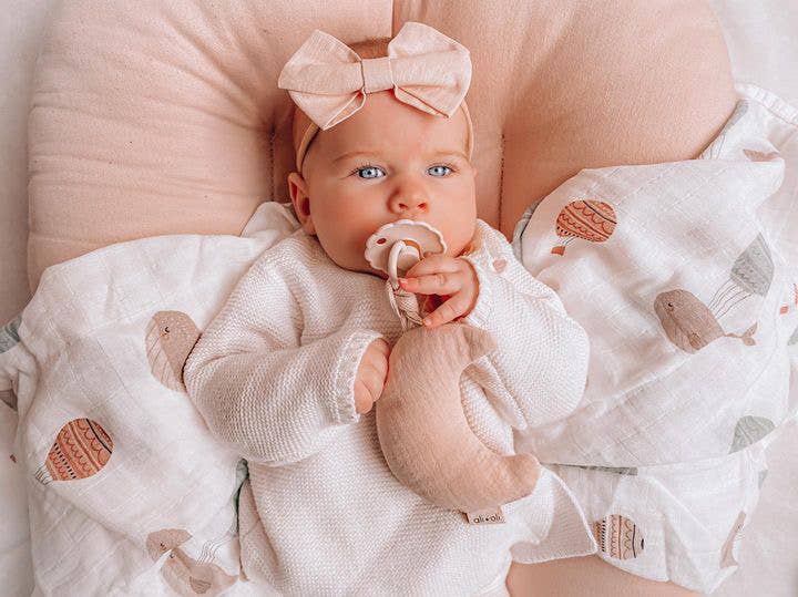 Ali+Oli bamboo muslin whale swaddle blanket lifestyle image newborn wrapped in soft organic bamboo cotton swaddle blanket