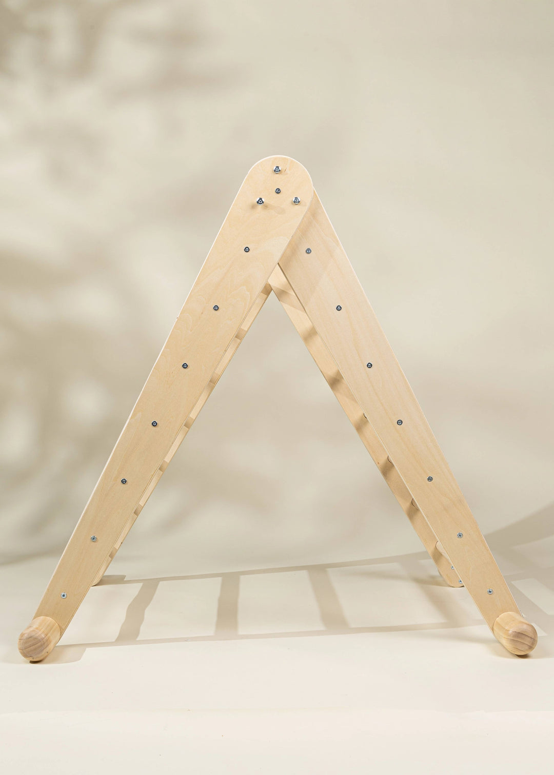 Made from Natural wood, the Coco Village Montessori 2-in-1 Triangle & Wall Climber helps toddlers thrive with a developmental toy design.