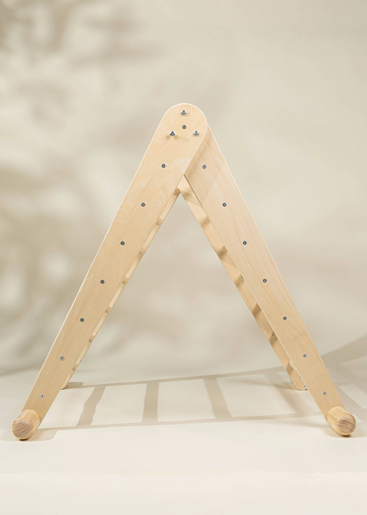 Made from Natural wood, the Coco Village Montessori 2-in-1 Triangle & Wall Climber helps toddlers thrive with a developmental toy design.