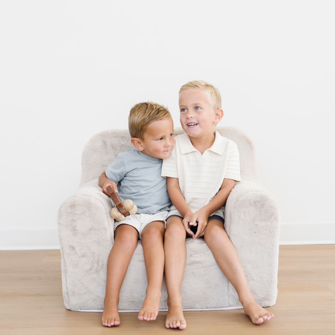 The Cream colored Saranoni Snuggle Up Chair offers a plush lounge chair for kids, perfect for relaxing or reading.