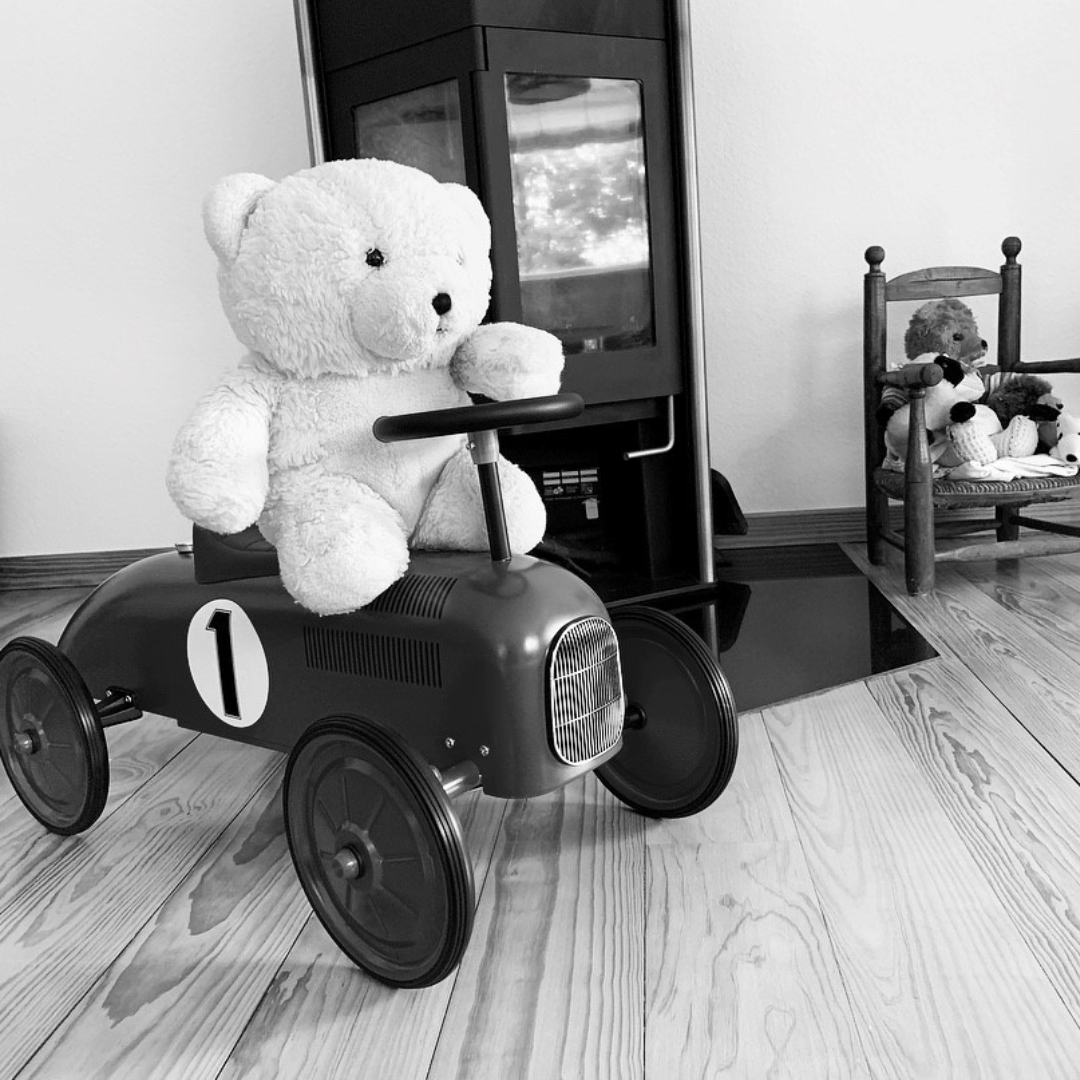 Toddlers can explore adventure with the Goki Classic Vintage Race Car Ride-On Vehicle, Black, a wooden toy.