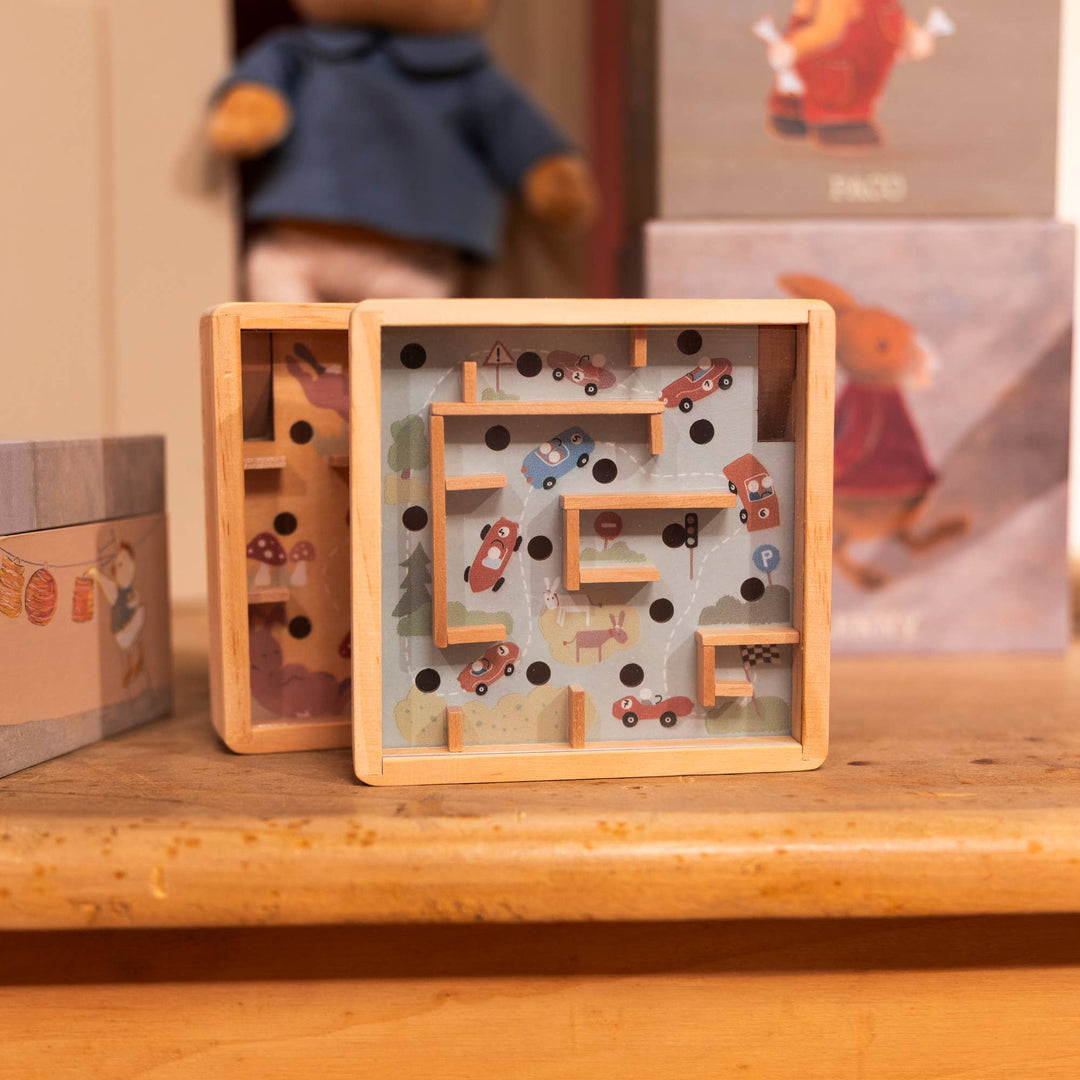 The Mini Wooden Labyrinth from Egmont stands beside its packaging box on a wooden shelf