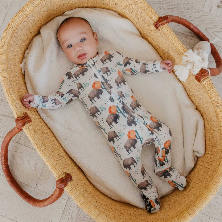 Baby wearing Copper Pearl Bison zip-up footie pajama, soft bamboo baby sleepwear for cozy nights and breathable comfort