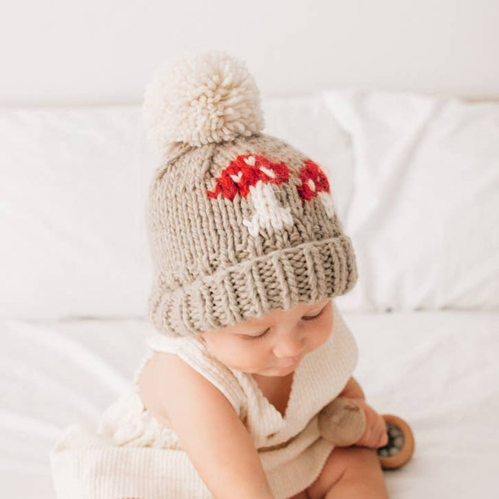 Close-up of the red mushroom design on this hand knit Oatmeal baby beanie hat