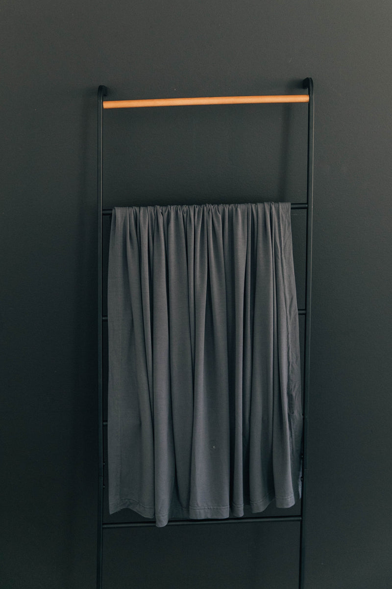 Wrap your infant securely in the Mebie Baby Charcoal Bamboo Stretch Swaddle, a soft baby blanket.