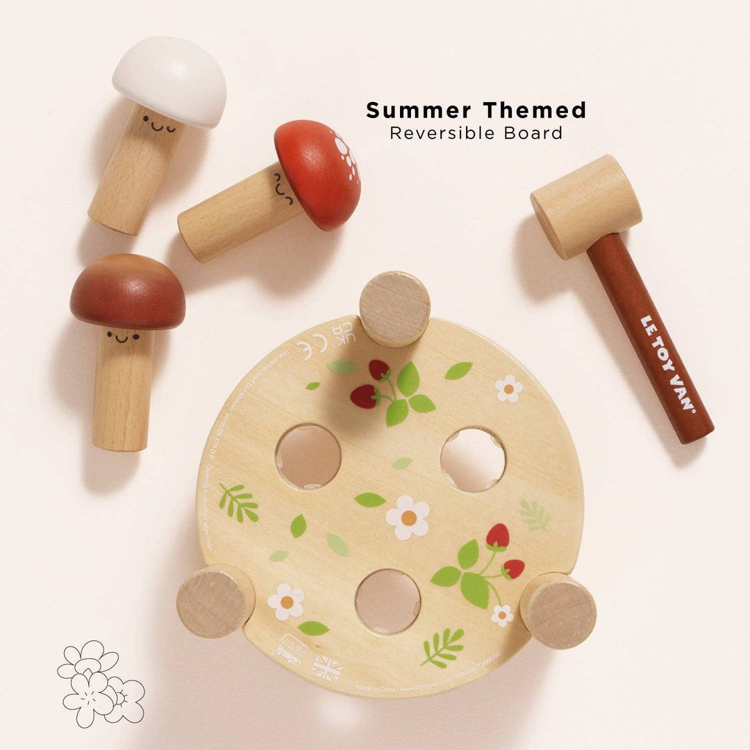 The same mushroom pieces rest on a reversible board painted with a summer floral design, Le Toy Van