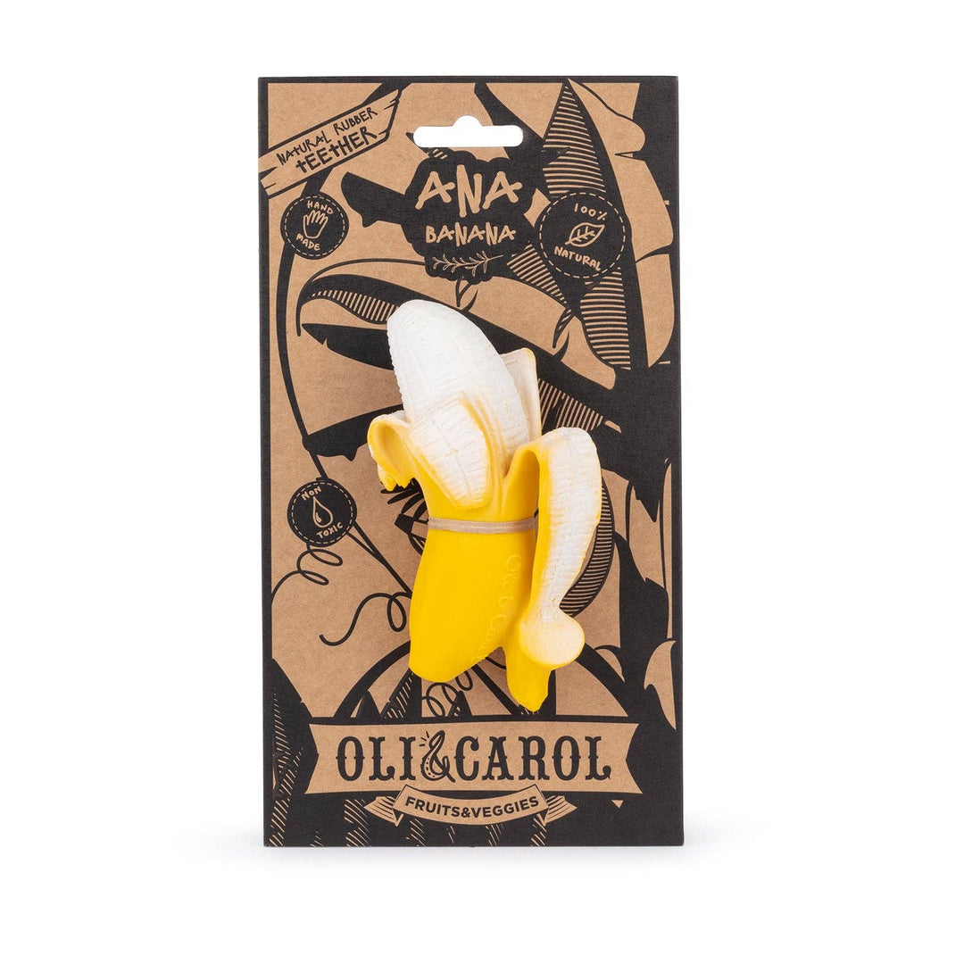 Oli & Carol Ana Banana teether held in baby's hand showing soft natural rubber texture