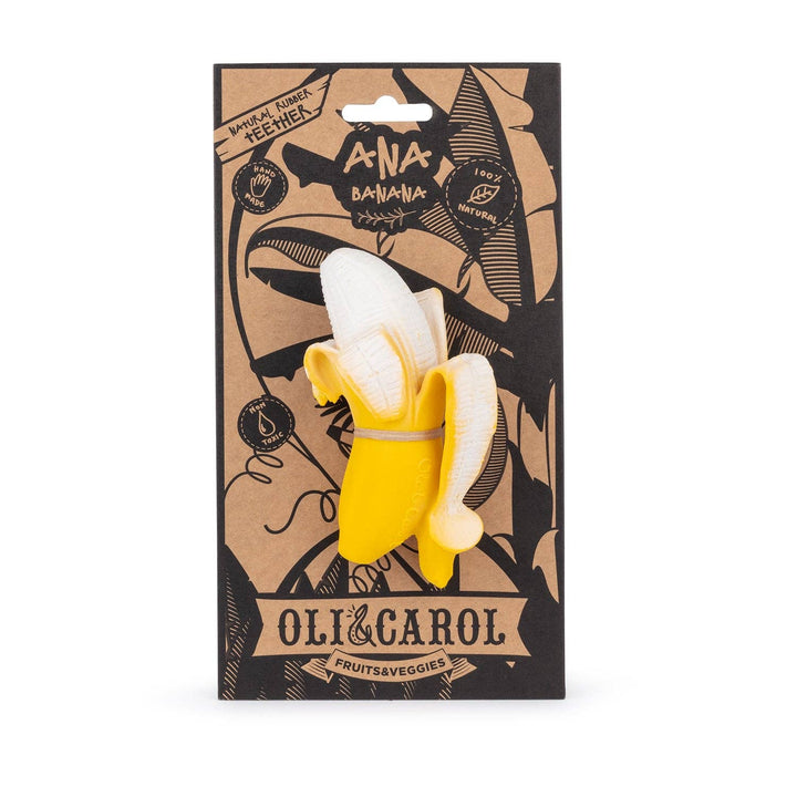 Oli & Carol Ana Banana teether held in baby's hand showing soft natural rubber texture