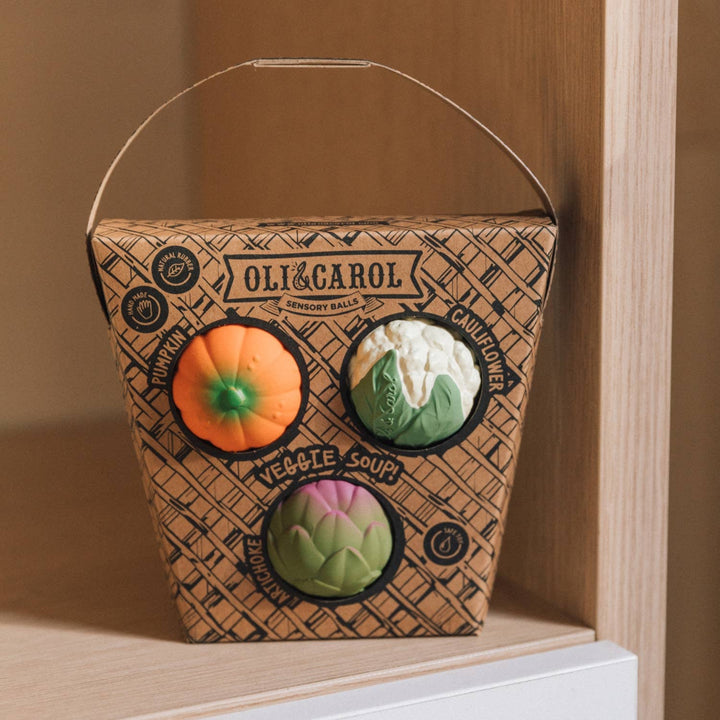 Veggie Soup Baby Sensory Balls box displayed on a wooden step at home