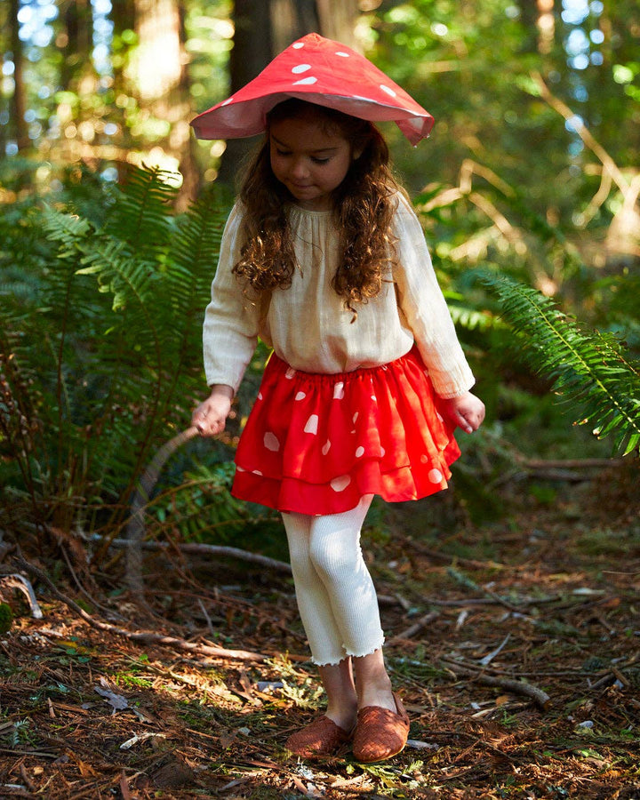 Red silk tutu worn outdoors imaginative play