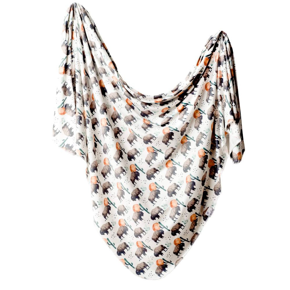 Newborn swaddled in Copper Pearl Bison knit receiving blanket