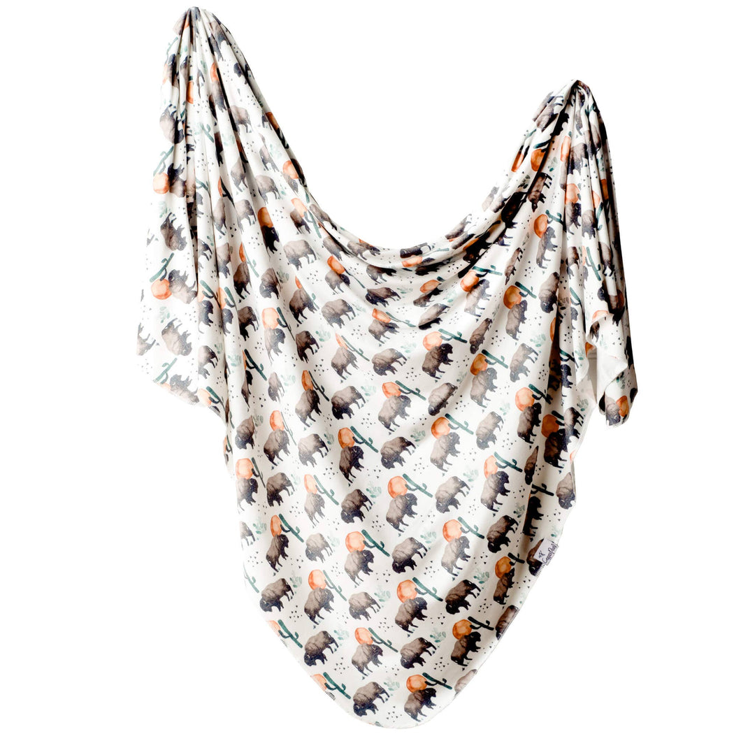 Newborn swaddled in Copper Pearl Bison knit receiving blanket