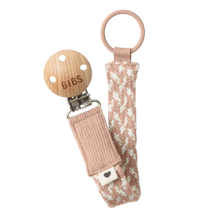 Soft blush and ivory BIBS Pacifier Clip keeps your baby pacifier secure in style.