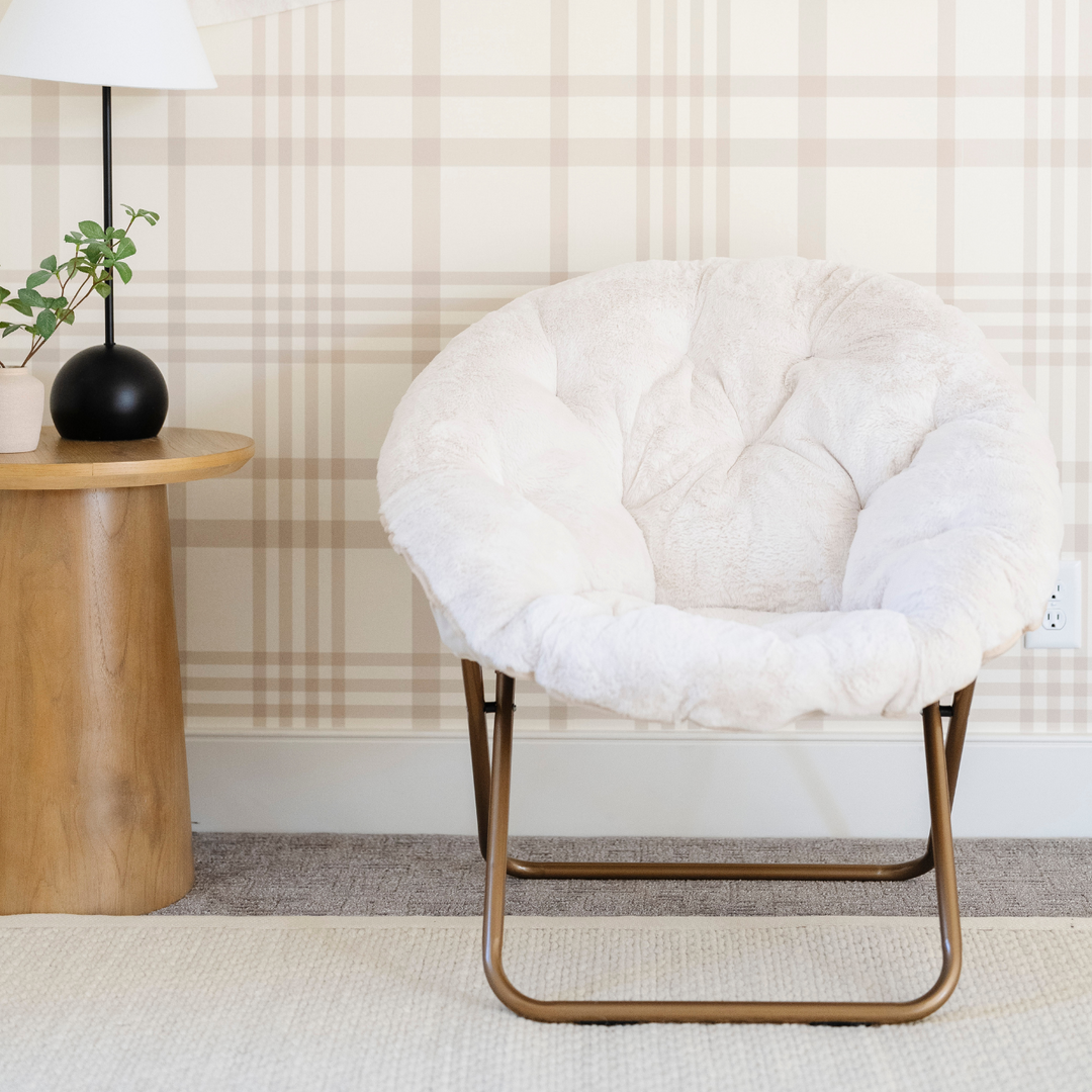 The Saranoni Saucer Chair in Cream serves as a comfy kids lounger for naps or reading.