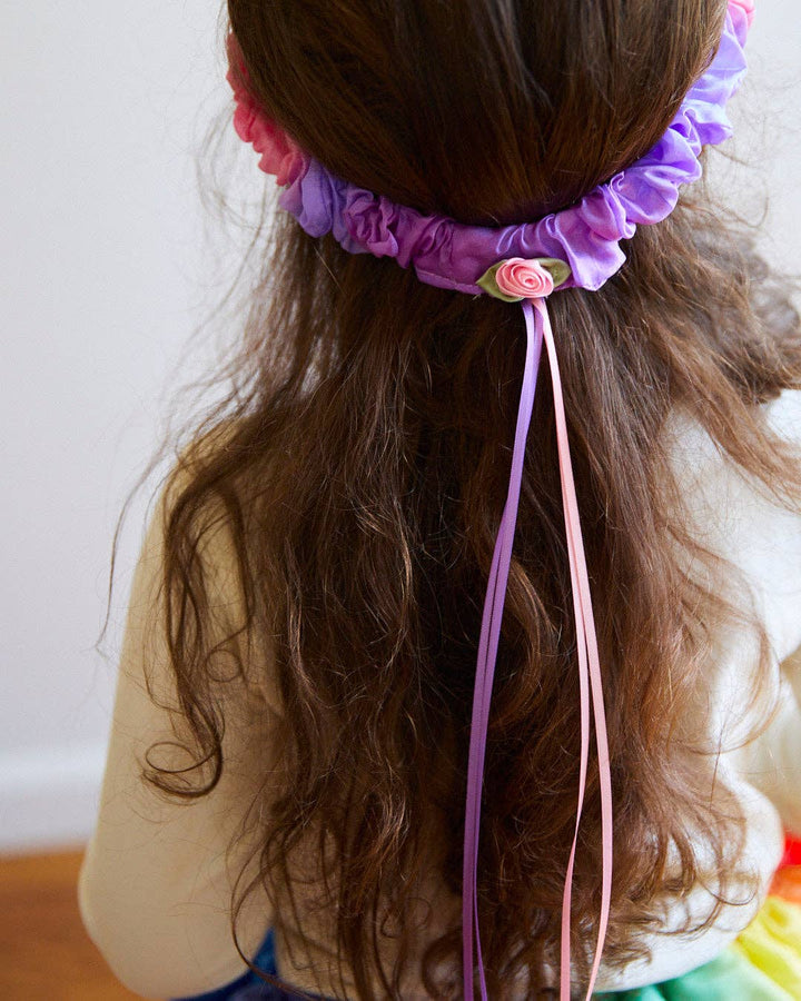 Long ribbons cascade from the Sarah's Silks Blossom Garland, worn here as a hair accessory
