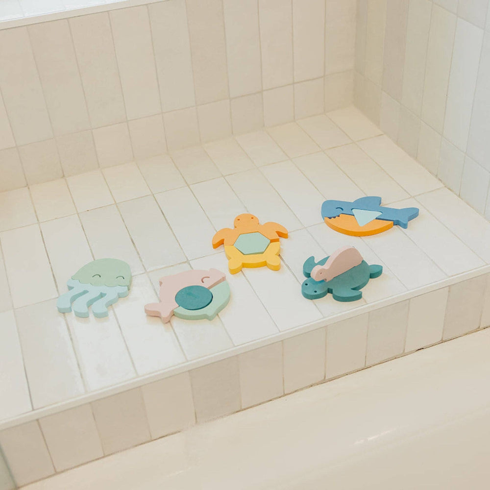 Foam bath toys on tub ledge, Copper Pearl ocean animal bath toys for toddlers and creative water play