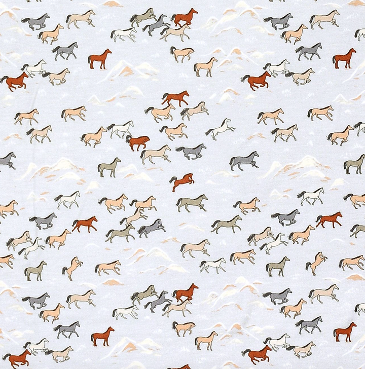 close up of apple park wild horses pattern for bamboo baby clothing 