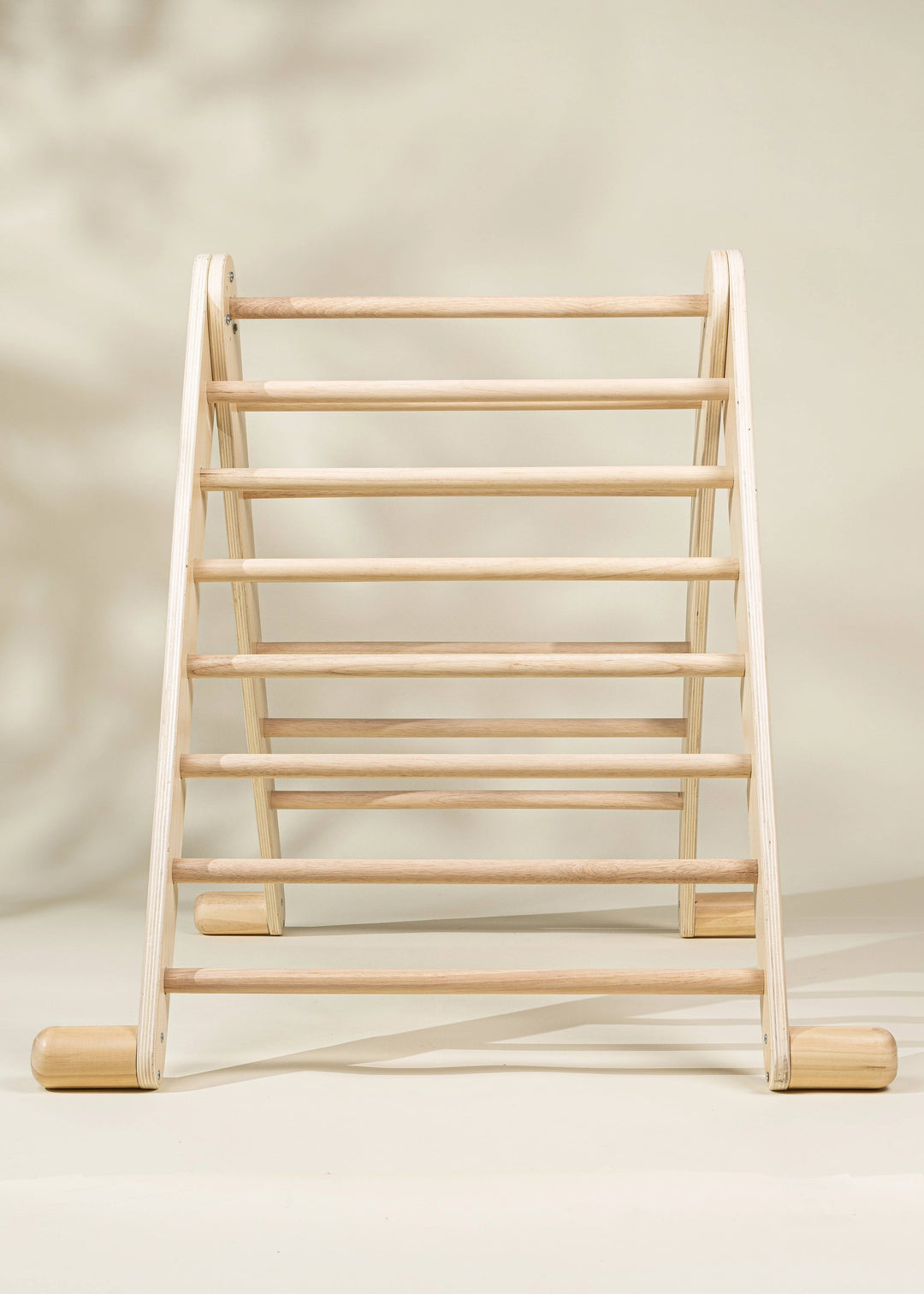 The Coco Village Montessori 2-in-1 Triangle & Wall Climber in Natural wood finish blends classic style and Montessori toy principles for growth.