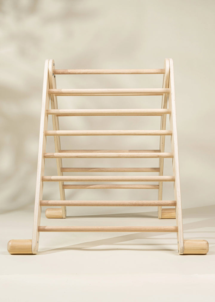 The Coco Village Montessori 2-in-1 Triangle & Wall Climber in Natural wood finish blends classic style and Montessori toy principles for growth.