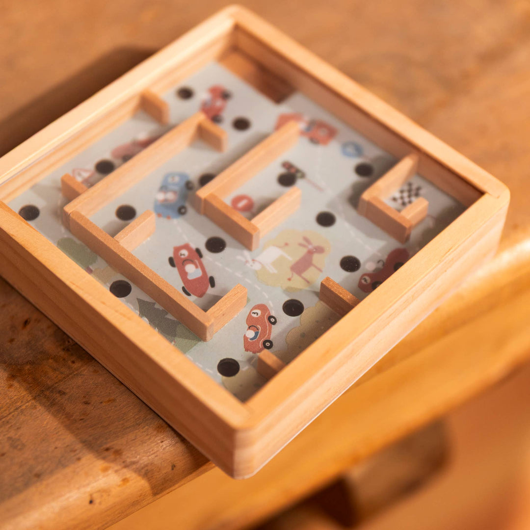 A close view on a wood table captures the smooth finish of Egmont's Mini Wooden Labyrinth