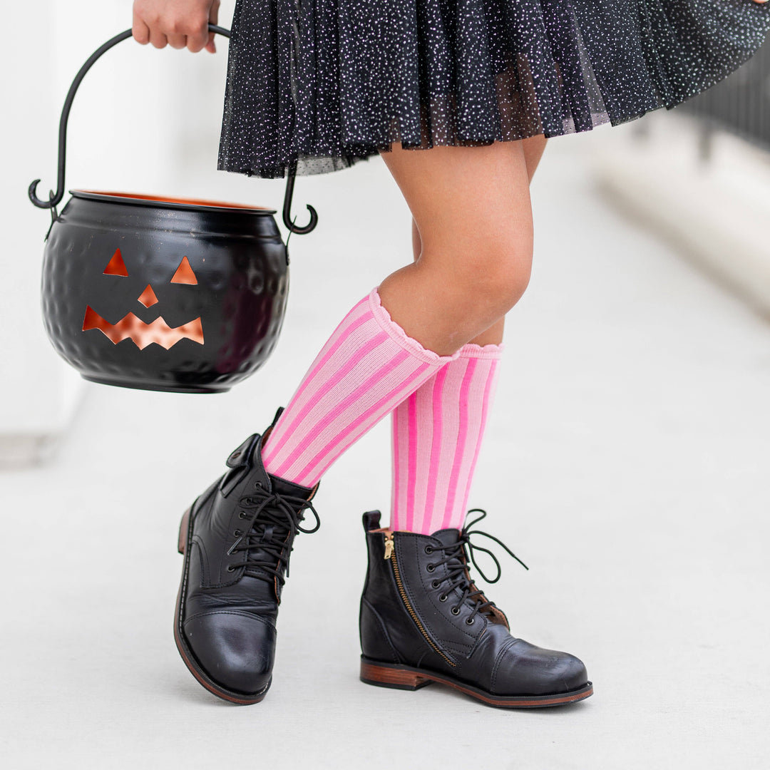 Trick-or-treating in Little Stocking Co. Blossom Striped socks, paired with lace-up boots and a pumpkin pail