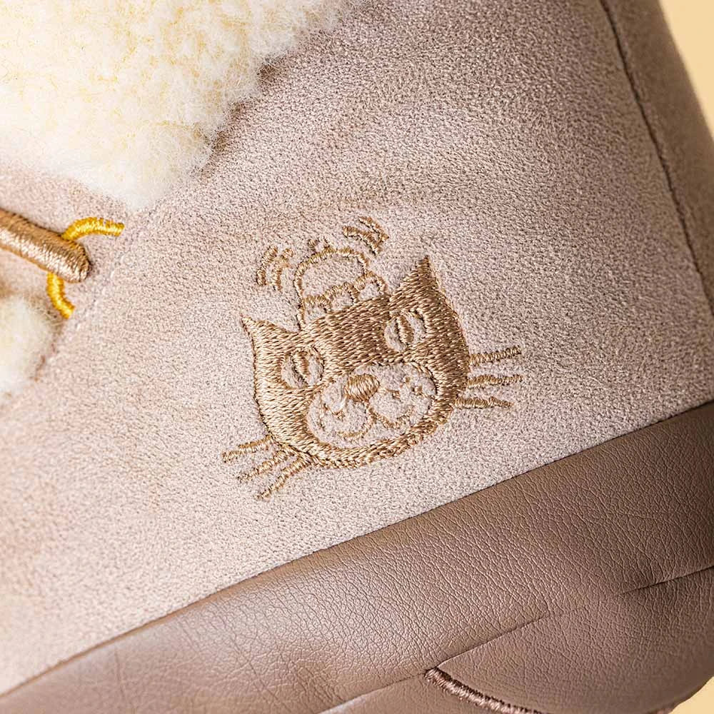 Close-up detail of Perta Snow Boot's smiling face, a Jellycat Amuseables winter plush gift