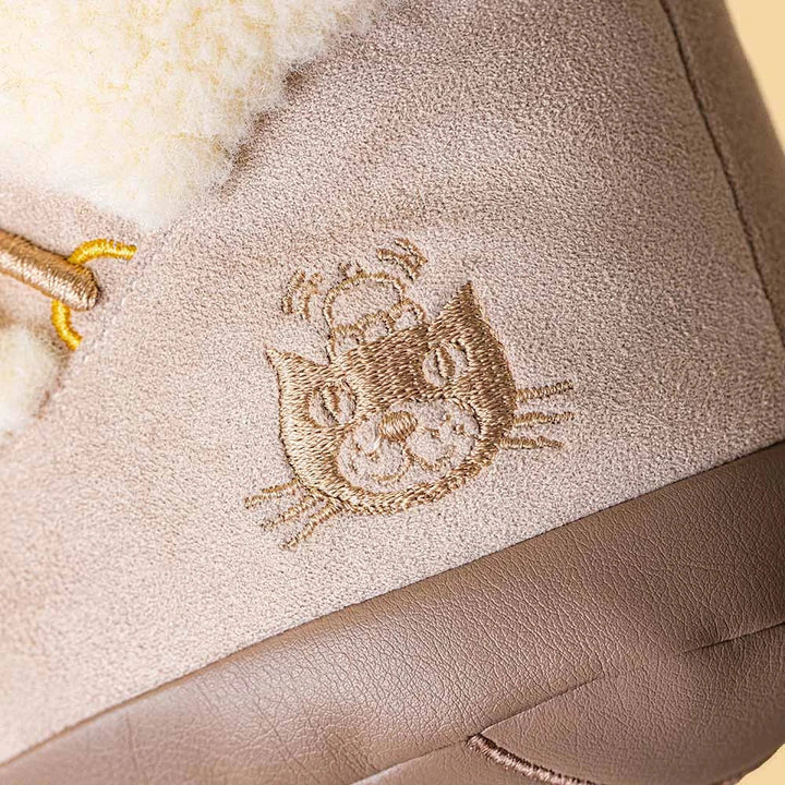 Close-up detail of Perta Snow Boot's smiling face, a Jellycat Amuseables winter plush gift