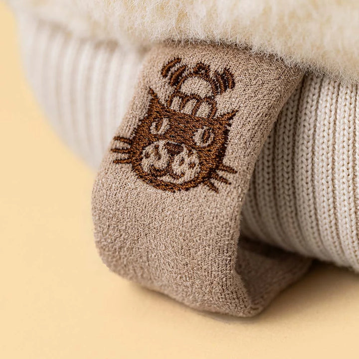 Close-up of Fitswell Mitten's smiling face, a Jellycat Amuseables winter plush collectible