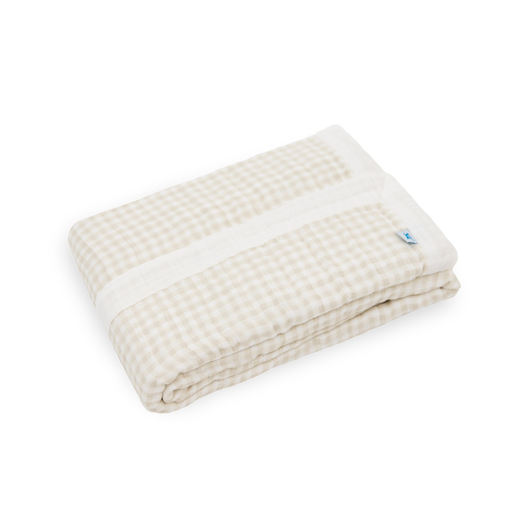 Close-up of Little Unicorn Cotton Muslin Baby Quilt - Tan Gingham showing lightweight muslin fabric and timeless gingham design.