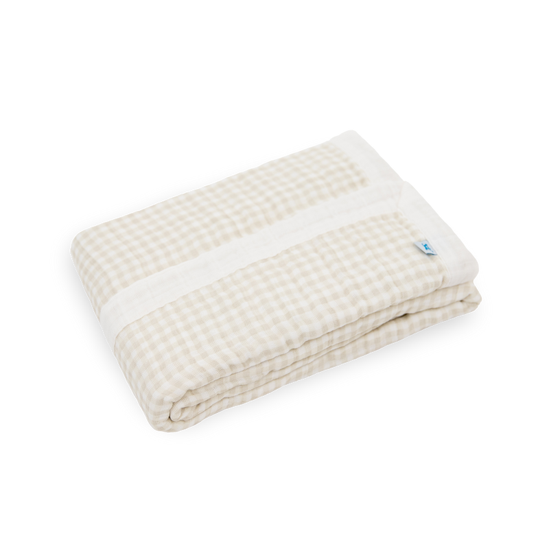 Close-up of Little Unicorn Cotton Muslin Baby Quilt - Tan Gingham showing lightweight muslin fabric and timeless gingham design.