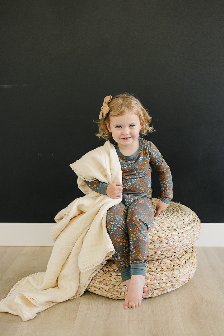 Nursery-ready, this Mebie Baby Cream Lace Muslin Quilt works as a stylish muslin throw blanket.