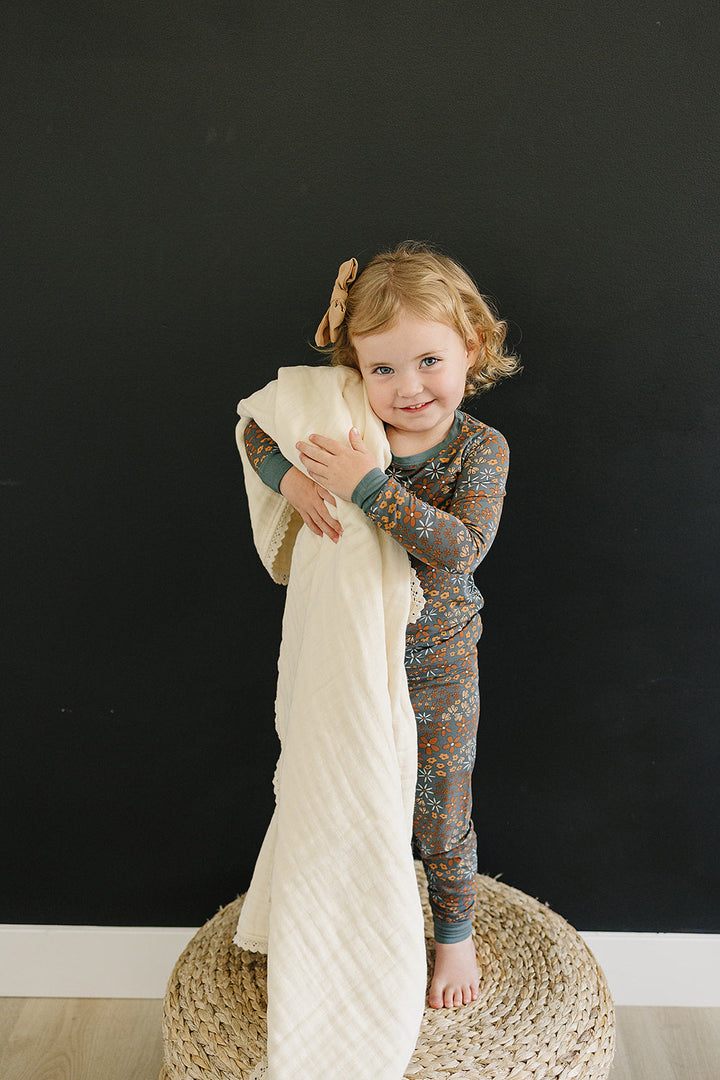 Wrapped in elegance, the Cream Lace Muslin Quilt by Mebie Baby is a cotton muslin blanket for babies.