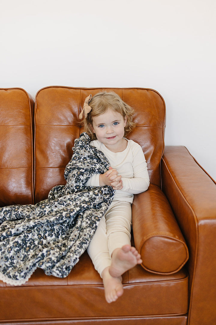 Lightweight and soft, the Liberty Floral + Coastal Plaid Lace Muslin Quilt is a versatile muslin baby blanket by Mebie Baby.