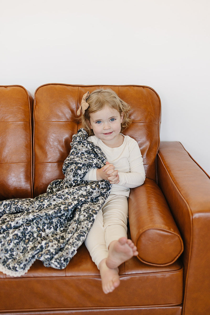 Lightweight and soft, the Liberty Floral + Coastal Plaid Lace Muslin Quilt is a versatile muslin baby blanket by Mebie Baby.