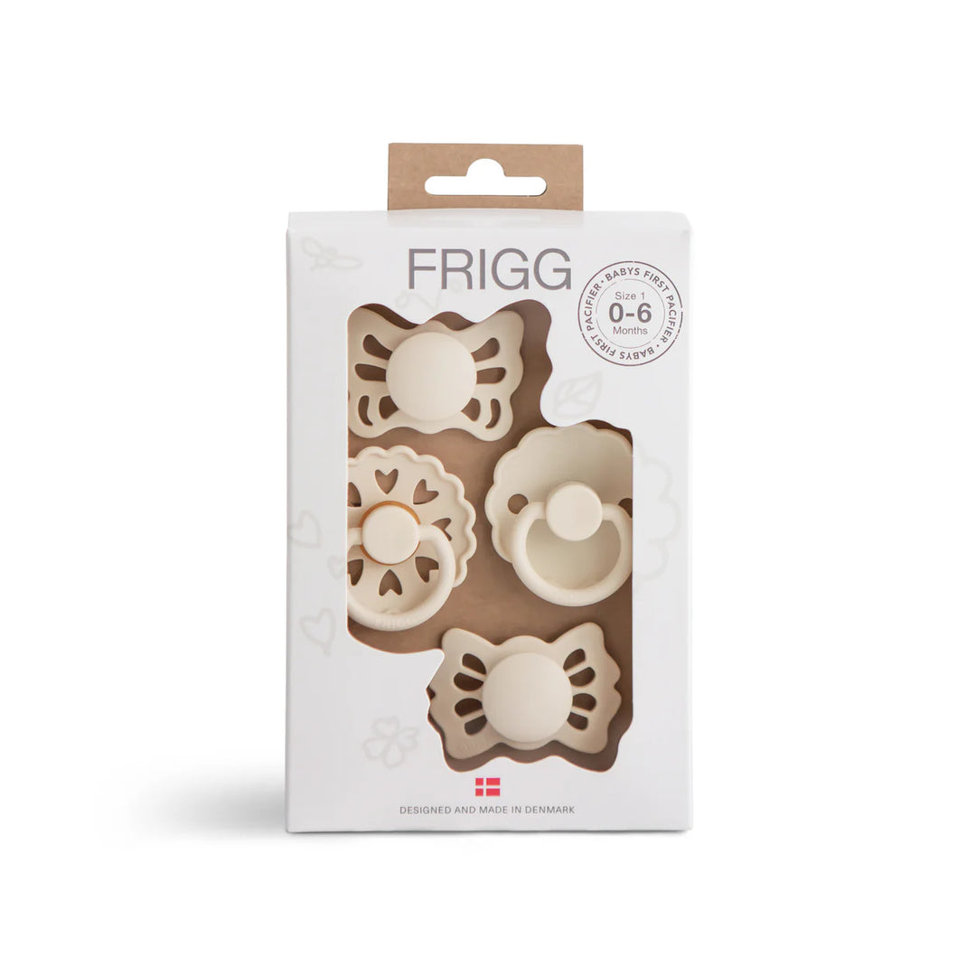 FRIGG Baby's First Floral Heart Cream pacifier 4-pack - four newborn soothers in cream packaging front view