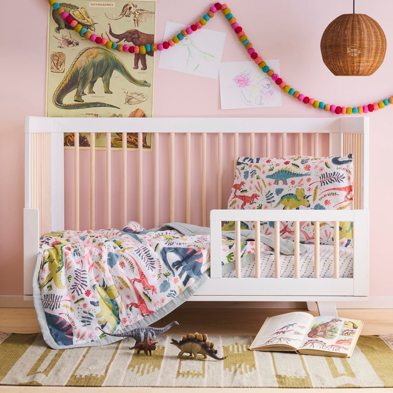 Styled crib with Little Unicorn Cotton Muslin Toddler Comforter - Boho Dino, soft sleep bag baby for secure rest.