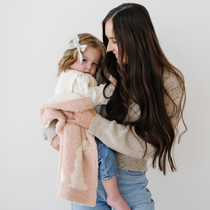 The Bunny Pink Saranoni Double-Layer BAMBONI¨ Mini Blanket wraps babies in ultra-soft comfort Ñ one of the best baby girl blankets.