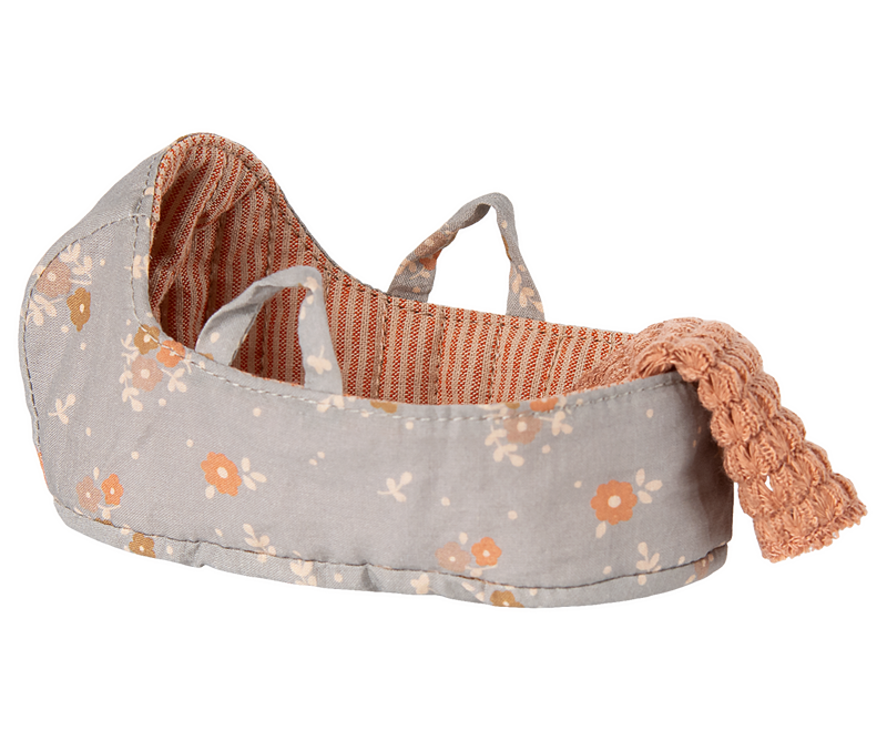 Shown here, the Maileg Micro Carry Cot adds a playful accent designed for beloved Maileg dolls.