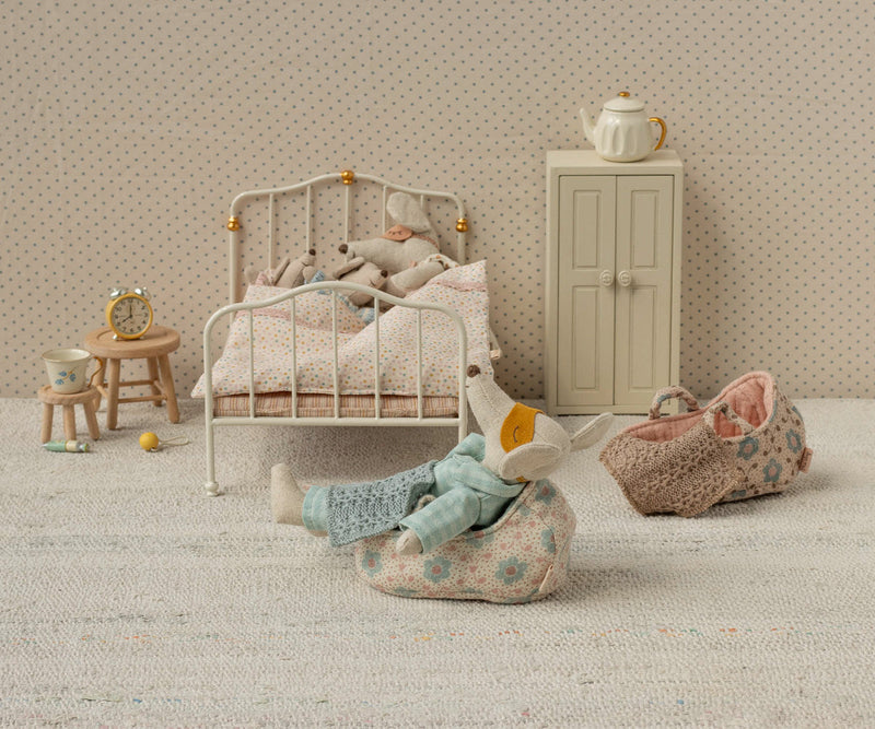 Bringing gentle charm to the scene, this Maileg Micro Carry Cot becomes a perfect companion for a stuffed doll.