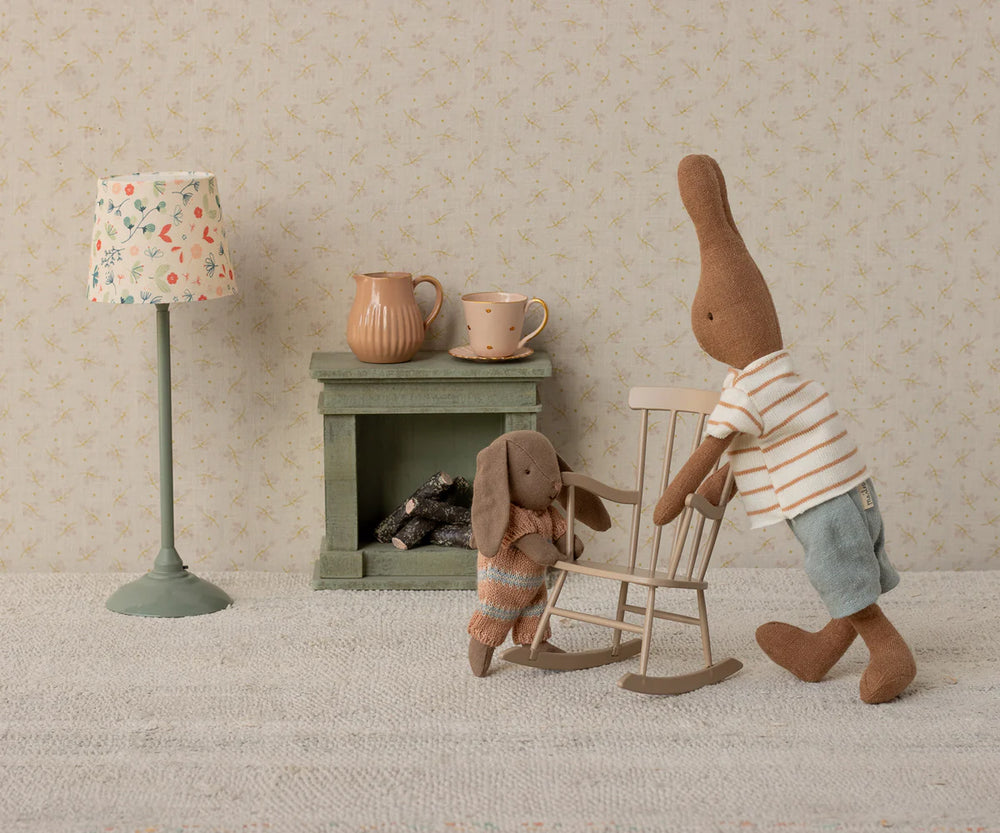 maileg rabbits playing with maileg dark sand rocking chair in staged dollhouse room